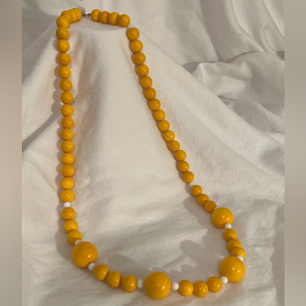 Long vintage yellow beaded necklace.